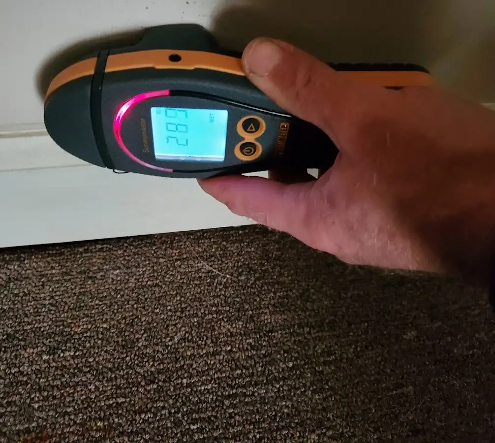 Moisture detection at baseboard during Storm Damage Restoration in Pitman